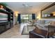 Comfortable living room with a ceiling fan, tv, lots of light, and tile flooring at 1001 Benjamin Franklin Dr # 110, Sarasota, FL 34236