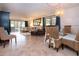 Spacious living room with tile floors, large windows, comfortable seating and stylish furnishings at 1001 Benjamin Franklin Dr # 110, Sarasota, FL 34236