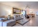 Inviting living room with open dining area, tile flooring, comfortable seating, and lots of light at 1001 Benjamin Franklin Dr # 110, Sarasota, FL 34236