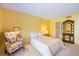 Bedroom featuring yellow walls, carpet, and wicker furniture at 235 Woodland Dr, Osprey, FL 34229