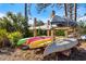 Colorful kayaks and canoes stored on a wooden rack near lush vegetation, ready for water adventures at 235 Woodland Dr, Osprey, FL 34229