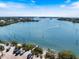 Beautiful waterfront view with boats, a sandy beach, and a clear blue sky enhancing the coastal charm at 235 Woodland Dr, Osprey, FL 34229