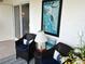 Comfortable balcony seating area with a cozy design and chairs with pillows, plus a lovely side table at 3756 Lake Bayshore # 509, Bradenton, FL 34205