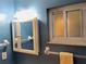 Bathroom featuring a medicine cabinet mirror, a towel rack, and a window on a blue wall at 3756 Lake Bayshore # 509, Bradenton, FL 34205