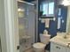 Bathroom featuring a glass shower with a seat, and a blue wall with a mirror and window at 3756 Lake Bayshore # 509, Bradenton, FL 34205
