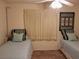 Bedroom featuring two twin beds with blue and green accents, carpeted floors, and a ceiling fan at 3756 Lake Bayshore # 509, Bradenton, FL 34205