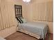 Bedroom featuring a twin bed with blue accents, carpeted floors, and a ceiling fan at 3756 Lake Bayshore # 509, Bradenton, FL 34205