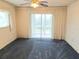 Empty bedroom with large balcony door and carpet at 3756 Lake Bayshore # 509, Bradenton, FL 34205