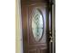 Elegant front door features decorative glass insert and dark wood finish at 3756 Lake Bayshore # 509, Bradenton, FL 34205