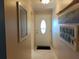 Entrance hallway with a white front door, decorative art, and tile flooring at 3756 Lake Bayshore # 509, Bradenton, FL 34205