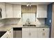 Modern kitchen with stainless steel sink, granite countertop, and mosaic backsplash at 3756 Lake Bayshore # 509, Bradenton, FL 34205