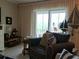 Bright living room featuring a chair, sofa, and nautical decor at 3756 Lake Bayshore # 509, Bradenton, FL 34205