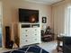 Living room featuring tile floors, white dresser, television, unique decor, and large window at 3756 Lake Bayshore # 509, Bradenton, FL 34205