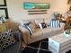 Comfortable living room with a soft couch, decorative pillows, and beach-themed decor at 3756 Lake Bayshore # 509, Bradenton, FL 34205