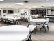 Spacious recreation room with white tables, chairs, library and laminate flooring at 3756 Lake Bayshore # 509, Bradenton, FL 34205