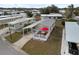 Charming mobile home featuring a cozy outdoor deck with an umbrella, covered parking and a well-maintained yard at 5539 Holiday Park Blvd, North Port, FL 34287