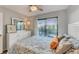 Relaxing bedroom with balcony access and tranquil neighborhood view at 6828 Midnight Pass Rd # 6828, Sarasota, FL 34242