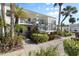 Attractive condo exterior, features a balcony, lush landscaping, and a welcoming entrance at 755 Village Cir # 203, Venice, FL 34292