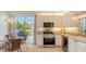 Bright modern kitchen with stainless steel appliances and ample counter space, perfect for cooking and entertaining at 7703 Whitebridge Gln, University Park, FL 34201