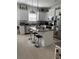Bright kitchen features stainless steel appliances, granite countertops, and an island with bar stool seating at 10923 Blue Magnolia Ln, Parrish, FL 34219