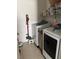 Laundry room features a side-by-side washer and dryer and shelving above for storage at 10923 Blue Magnolia Ln, Parrish, FL 34219