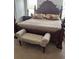 Main bedroom featuring a large bed with an upholstered bench seat at 10923 Blue Magnolia Ln, Parrish, FL 34219