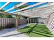 Shady pergola in the backyard with artificial turf at 1104 83Rd Nw St, Bradenton, FL 34209