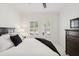 Cozy bedroom with natural light, neutral decor, and dark wood accents at 14614 Newtonmore Ln, Lakewood Ranch, FL 34202