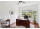 Bright home office featuring hardwood floors, a ceiling fan, and a large window at 14614 Newtonmore Ln, Lakewood Ranch, FL 34202