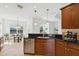 Open kitchen with stainless steel dishwasher, wine rack, and breakfast area for seamless entertaining at 14614 Newtonmore Ln, Lakewood Ranch, FL 34202