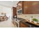 Kitchen area with stainless steel appliances, beautiful countertops, and stylish wood cabinetry at 14614 Newtonmore Ln, Lakewood Ranch, FL 34202
