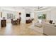 Open living room showcases tile flooring and a view to the dining room and outdoor living spaces at 14614 Newtonmore Ln, Lakewood Ranch, FL 34202