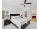 Bright main bedroom with ceiling fan, tray ceiling and view to ensuite bathroom at 14614 Newtonmore Ln, Lakewood Ranch, FL 34202