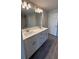 Modern bathroom with double vanity, quartz countertop, and a large mirror at 2640 Averland Loop, North Port, FL 34287