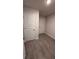 Hallway with tile flooring and two white doors at 2640 Averland Loop, North Port, FL 34287