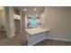 Bright kitchen with white cabinets, quartz countertops, and a central island at 2640 Averland Loop, North Port, FL 34287