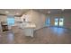 Open-concept kitchen featuring white cabinets, island, and stainless steel appliances at 2640 Averland Loop, North Port, FL 34287