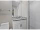 Bright bathroom featuring a granite countertop vanity and a glass-enclosed tiled shower at 330 Caruso Pl, Sarasota, FL 34237