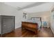 Cozy bedroom with rich hardwood floors, a large dresser, and ample natural light from multiple windows at 330 Caruso Pl, Sarasota, FL 34237