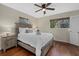 Bright bedroom with hardwood floors, ceiling fan, large windows, and a neutral color palette at 330 Caruso Pl, Sarasota, FL 34237