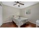 Bright bedroom with hardwood floors, ceiling fan, large windows, and neutral earth tone colored bedding at 330 Caruso Pl, Sarasota, FL 34237