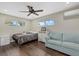 Comfortable bedroom featuring a queen-sized bed, laminate floors, and a mini-split A/C at 330 Caruso Pl, Sarasota, FL 34237
