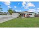 Charming home featuring a well-maintained lawn, fresh landscaping, and a one car garage at 330 Caruso Pl, Sarasota, FL 34237