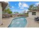 A beautiful kidney-shaped pool is surrounded by a brick-paved deck and tall fencing at 330 Caruso Pl, Sarasota, FL 34237