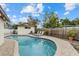 Refreshing kidney-shaped pool surrounded by a paver deck and privacy fence at 330 Caruso Pl, Sarasota, FL 34237