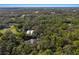 Aerial shot of a home surrounded by dense trees, showcasing the property's private and secluded setting at 3395 Hardee Dr, Venice, FL 34292