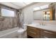 Modern bathroom featuring updated tub, gray tile, and vanity at 3395 Hardee Dr, Venice, FL 34292