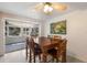 Open dining area with large wood table and sunroom access at 3395 Hardee Dr, Venice, FL 34292