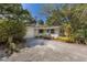 Charming single story home with mature trees and gravel driveway at 3395 Hardee Dr, Venice, FL 34292