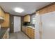Traditional kitchen featuring wood cabinets, appliances, and a practical design at 3395 Hardee Dr, Venice, FL 34292